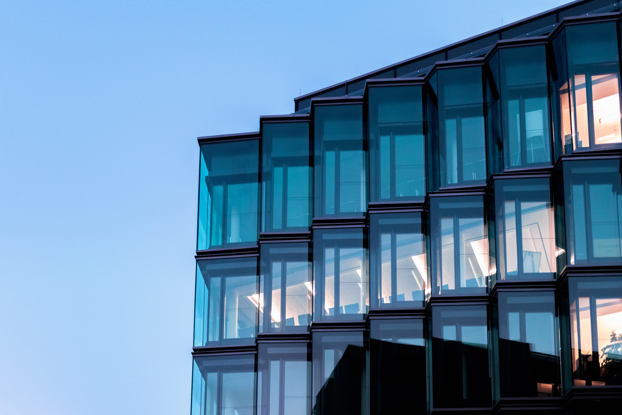 modern glass facade of new architecture in berlin at blue hour