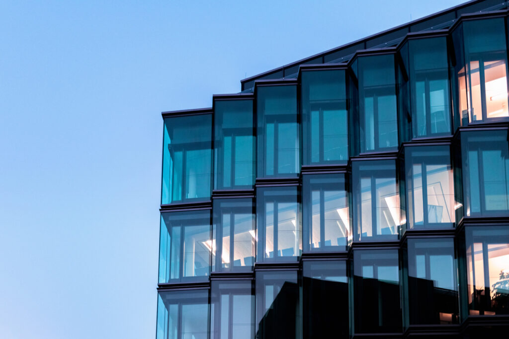 modern glass facade of new architecture in berlin at blue hour